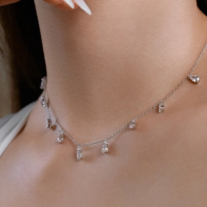 Close-up of elegant S925 silver necklace with pear-cut cubic zirconia pendants on model