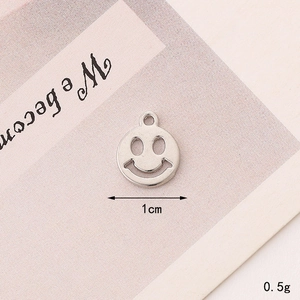 Detail of silver smiley face charm measuring 1cm and weighing 0.5g for DIY jewelry