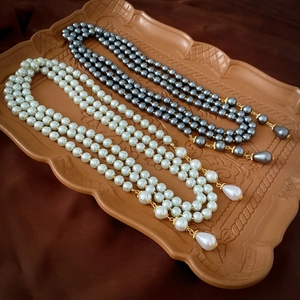 Elegant multi-layered long pearl necklaces in white and grey with waterdrop pendants