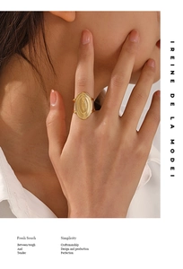 Macro shot of 18K gold plated oval ring with radial textures and adjustable band