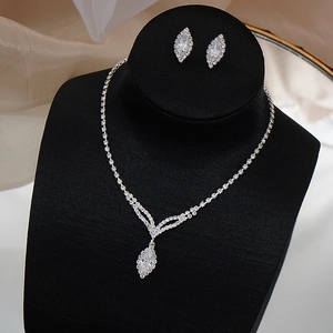 Detail of marquise-cut zircon bridal necklace and earrings set on black velvet display