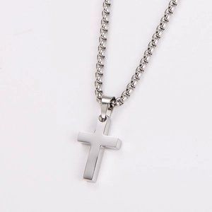 Close-up of polished silver stainless steel cross pendant with a Venetian box chain
