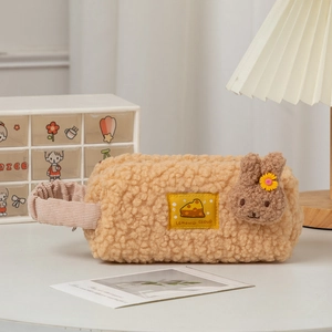 Close-up of plush cartoon pencil case with rabbit decor and cheese embroidery detail