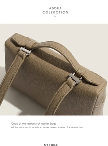 Detailed close-up of taupe litchi grain leather handbag with stitching and metal hardware