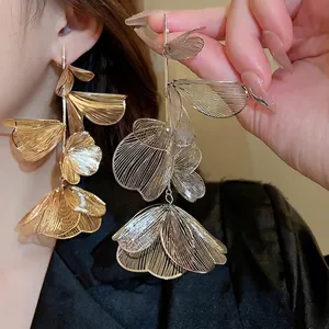 Exaggerated metal hollow flower tassel earrings with layered vintage gold texture