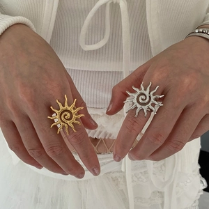 Minimalist sun-shaped open ring with textured gold and silver spiral flame design