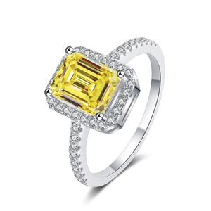 Macro shot of 1ct emerald-cut yellow moissanite ring with S925 sterling silver halo band