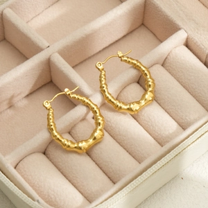Macro shot of gold bamboo textured hoop earrings made of durable waterproof stainless steel