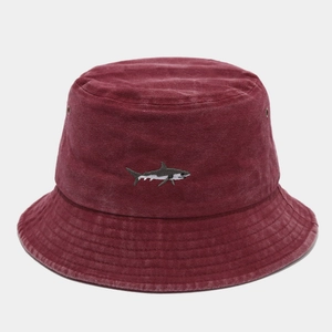 Detail of shark embroidery and metal eyelet on washed cotton burgundy bucket hat