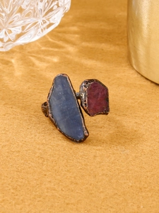 Detailed view of vintage open ring with raw blue and purple gemstones on bronze band