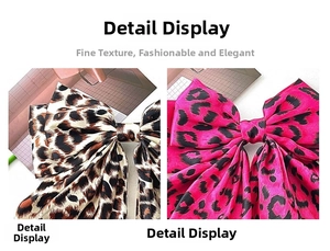 Detail view of large leopard print bow hair clips in brown and pink silky fabric