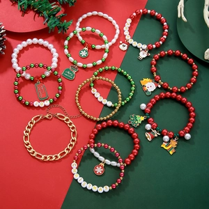 Detail of Christmas beaded bracelets with Santa, snowflake charms and Merry Christmas text