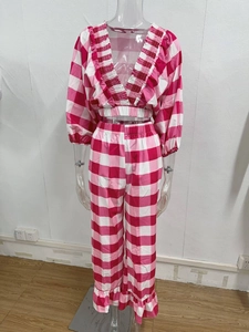 Detailed view of pink gingham V-neck cropped top and matching ruffled hem pants set