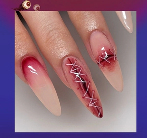 Detail of 3D Halloween stiletto press-on nails with realistic blood splatter and eye decor