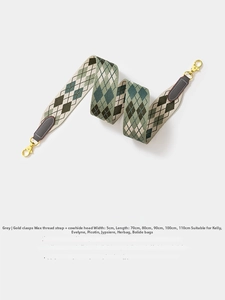 Close-up of woven geometric grey and green strap with gold hardware and leather details