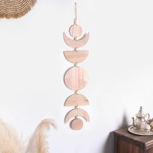 Bohemian style wooden moon phase wall hanging with natural wood grain texture on white wall