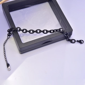 Detail of black oval link chain bracelet with lobster clasp and adjustable extension link