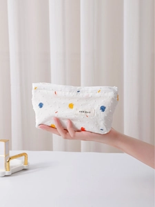 Polka dot fabric cosmetic bag for women with H&R BAG label and textured material