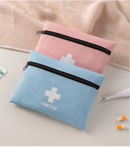 Detail view of pink and blue portable first aid kits with frosted texture and top zipper