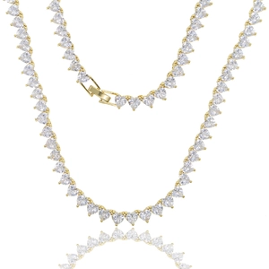 Detailed close-up of golden tennis chain featuring heart-shaped cubic zirconia stones