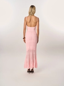 Close-up of pink crochet knit dress showing backless design and intricate hollow-out texture