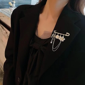 Elegant gold crystal flower tassel brooch with pearl number 5 on black suit jacket