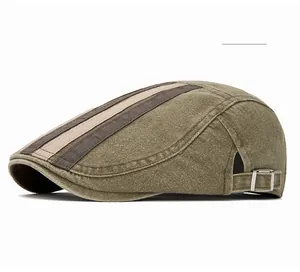 Detail view of the metal adjustment buckle and striped washed cotton fabric on olive flat cap