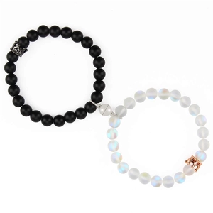 Detail of magnetic couple bracelets featuring matte black and iridescent white crown beads