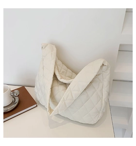Detail of soft quilted ivory hobo bag with cloud-like texture for casual commuting