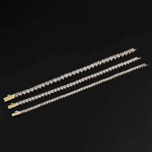 Detailed view of three gold hip-hop tennis bracelets with round-cut zircon stones
