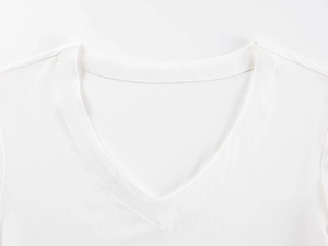 Close-up of the V-neckline and fine stitching on a white cotton slim-fit T-shirt