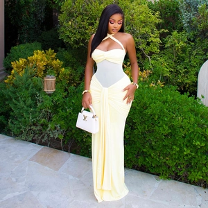 Detail of cross halter neckline and sheer mesh waist panel on a yellow evening dress
