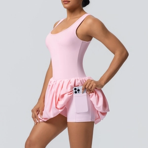 Pink tennis dress with built-in shorts featuring a side phone pocket and pleated skirt