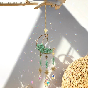 Moon-shaped suncatcher with green natural stones and crystal prisms in golden metal