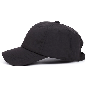 Minimalist solid black baseball cap with adjustable strap and curved brim in 45-degree view