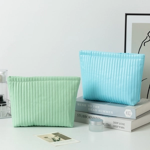 Waterproof quilted makeup bags in mint green and sky blue with a premium zipper closure