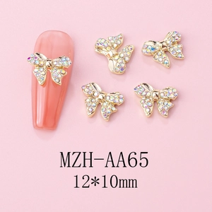 Macro detail of alloy bowknot nail art charms with iridescent rhinestones 12x10mm size