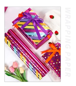 Close-up of colorful striped and polka dot wrapping paper with ribbons and gift boxes