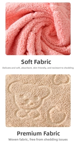 Macro shot of soft coral fleece towel fabric with embossed bear and heart patterns