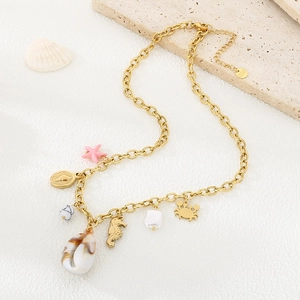Detailed view of stainless steel gold chain with sea shells, seahorse and starfish charms