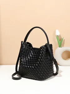 Fashionable black woven leather bucket bag with top handle and adjustable strap