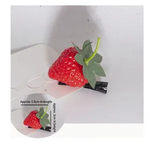 Close-up of realistic 3D strawberry hair clip with measurements 5.5cm by 3cm size details