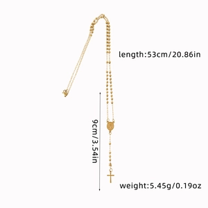 Detailed view of 3mm gold beaded rosary necklace with Virgin Mary medal and cross