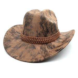 Vintage western cowboy hat in tan with distressed tie-dye texture and woven band