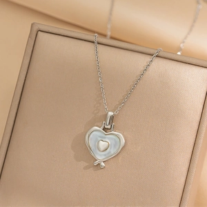 Silver titanium steel heart necklace with mother of pearl inlay on jewelry box