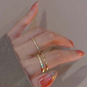 Detail of gold-plated double-layer ring featuring zircon stones and white mother-of-pearl