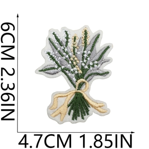 Detail showing embroidered green floral patch dimensions 6cm by 4.7cm with golden bow