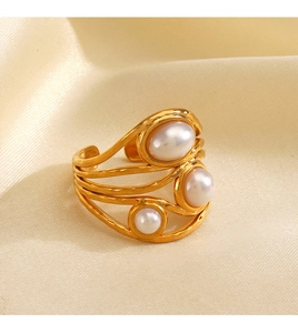 Macro detail of 18K gold plated irregular wavy ring with three inlaid pearls on silk