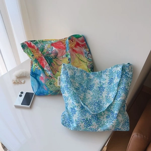 Detail of floral and tropical print cotton tote bags with simple wish woven label