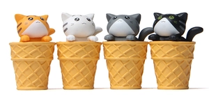 Detailed view of four colorful miniature cats in waffle ice cream cones for home decor